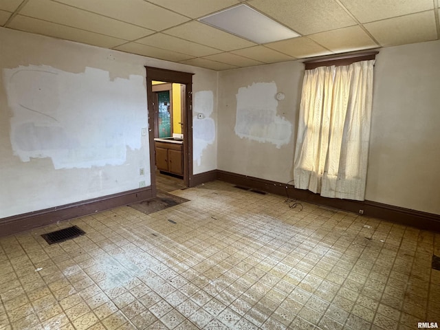 spare room featuring a drop ceiling