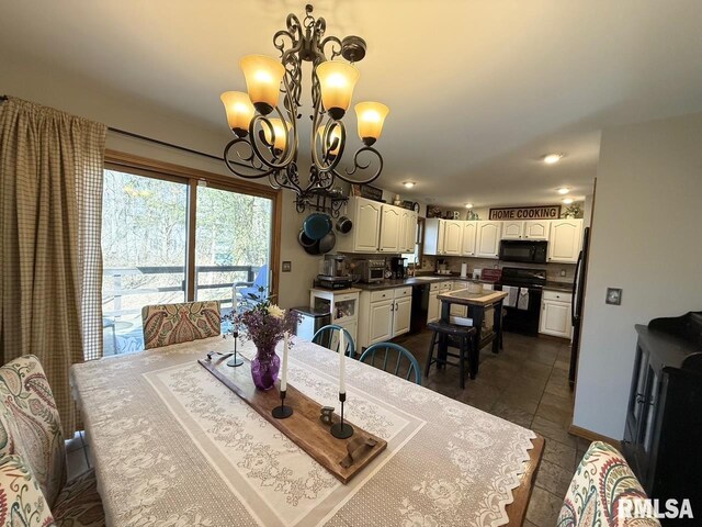 dining area featuring a chandelier, baseboards, and dark tile patterned floors