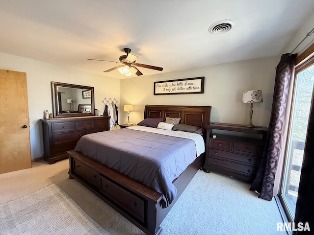 bedroom with a ceiling fan, visible vents, and light carpet