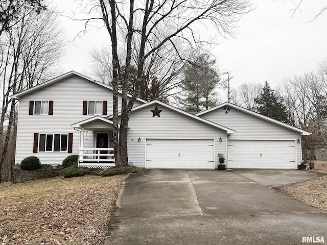 traditional-style home with a porch, an attached garage, and driveway