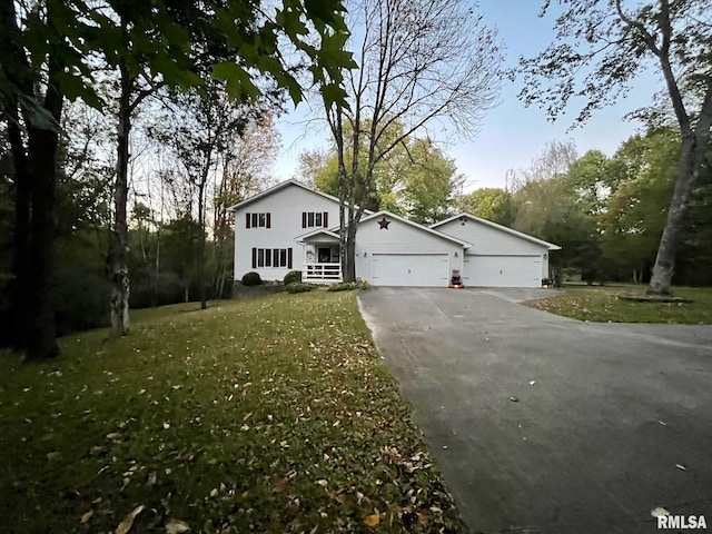 traditional-style house with a garage, a front lawn, and driveway