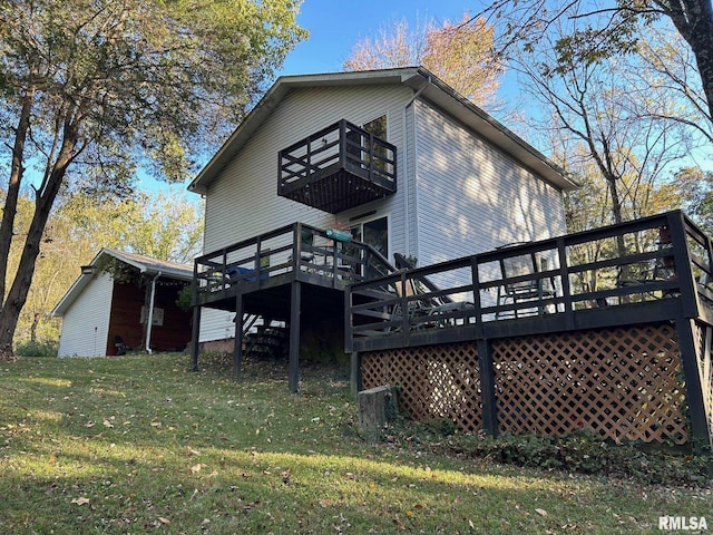 back of property featuring a balcony and a yard