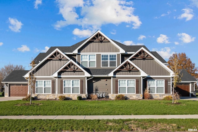 craftsman-style house with a garage and a front lawn