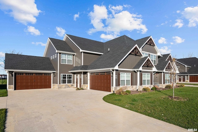 craftsman-style home featuring a garage and a front lawn