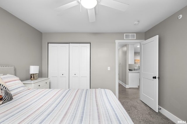 bedroom with ceiling fan, carpet, and a closet