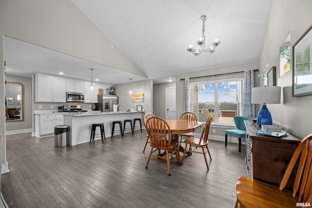 dining area featuring sink, high vaulted ceiling, dark hardwood / wood-style floors, and a chandelier