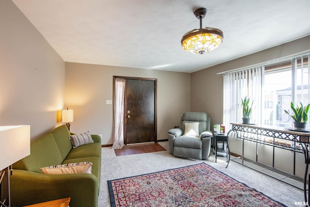 living area with baseboards and carpet flooring