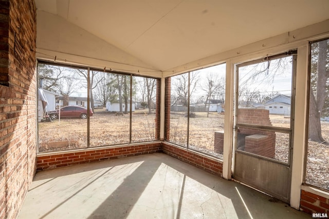 unfurnished sunroom with vaulted ceiling and plenty of natural light