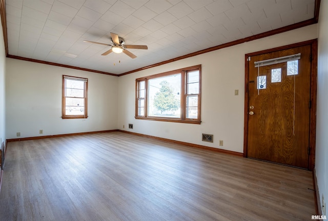 interior space with crown molding, wood-type flooring, and ceiling fan