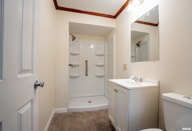 bathroom with vanity, crown molding, toilet, and walk in shower