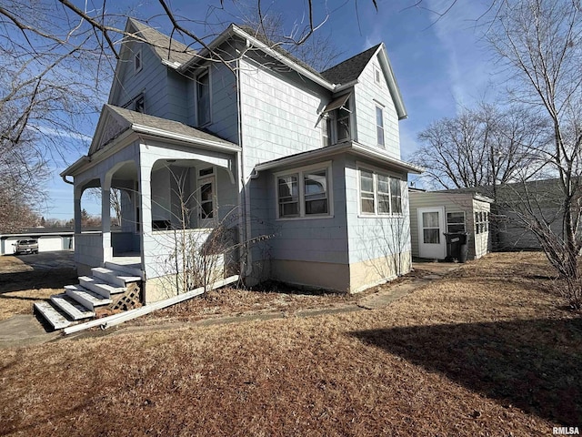 view of side of property featuring a porch