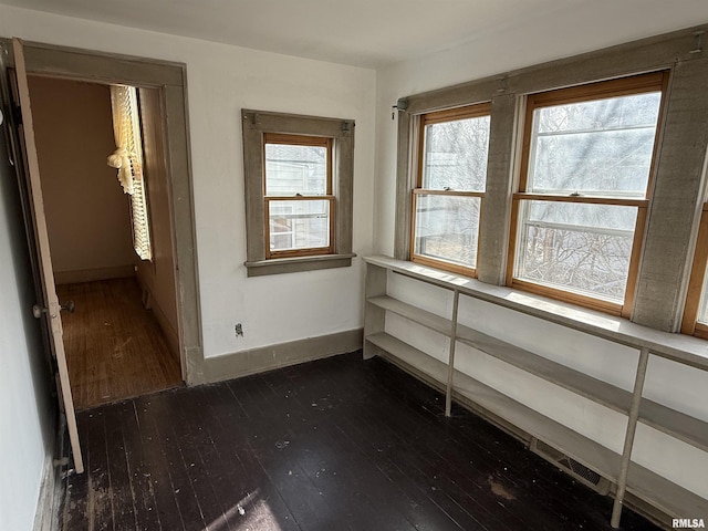 spare room featuring dark wood-type flooring