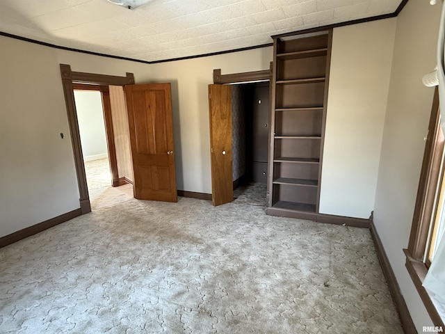 unfurnished bedroom with crown molding and carpet floors