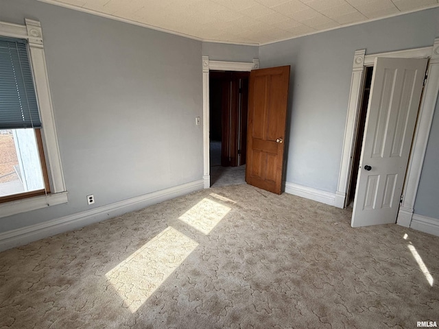 unfurnished bedroom featuring light carpet