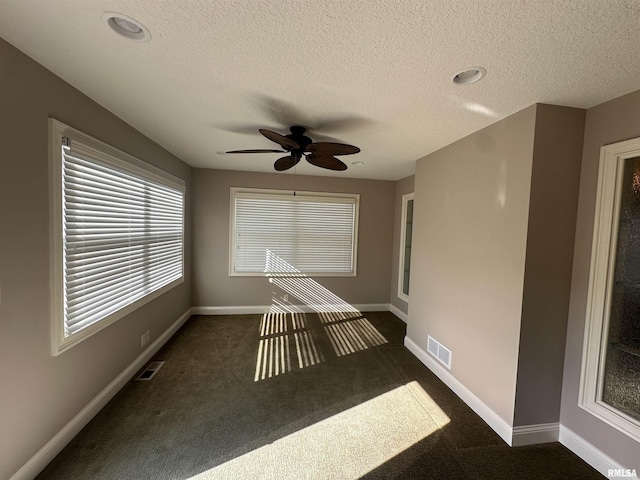 unfurnished sunroom with ceiling fan