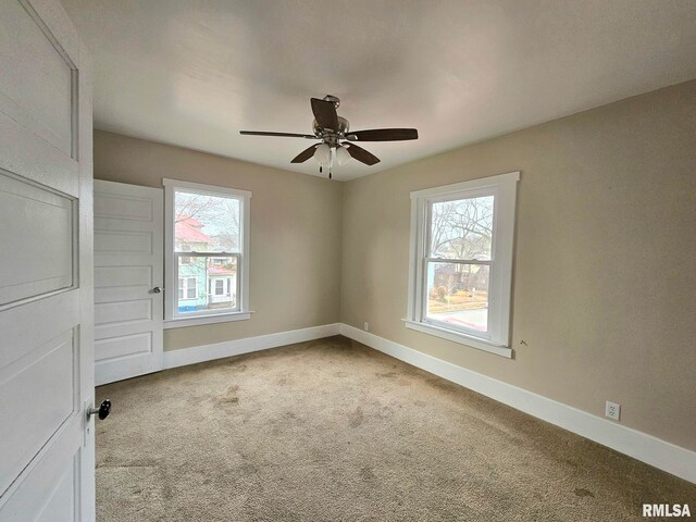 620 Sycamore St, Muscatine, IA 52761 - carpeted empty room with baseboards and ceiling fan