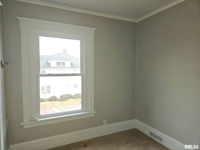 620 Sycamore St, Muscatine, IA 52761 - carpeted spare room featuring baseboards, a healthy amount of sunlight, visible vents, and ornamental molding