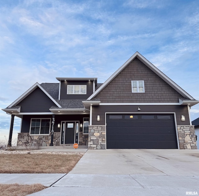 view of front of property featuring a garage and covered porch