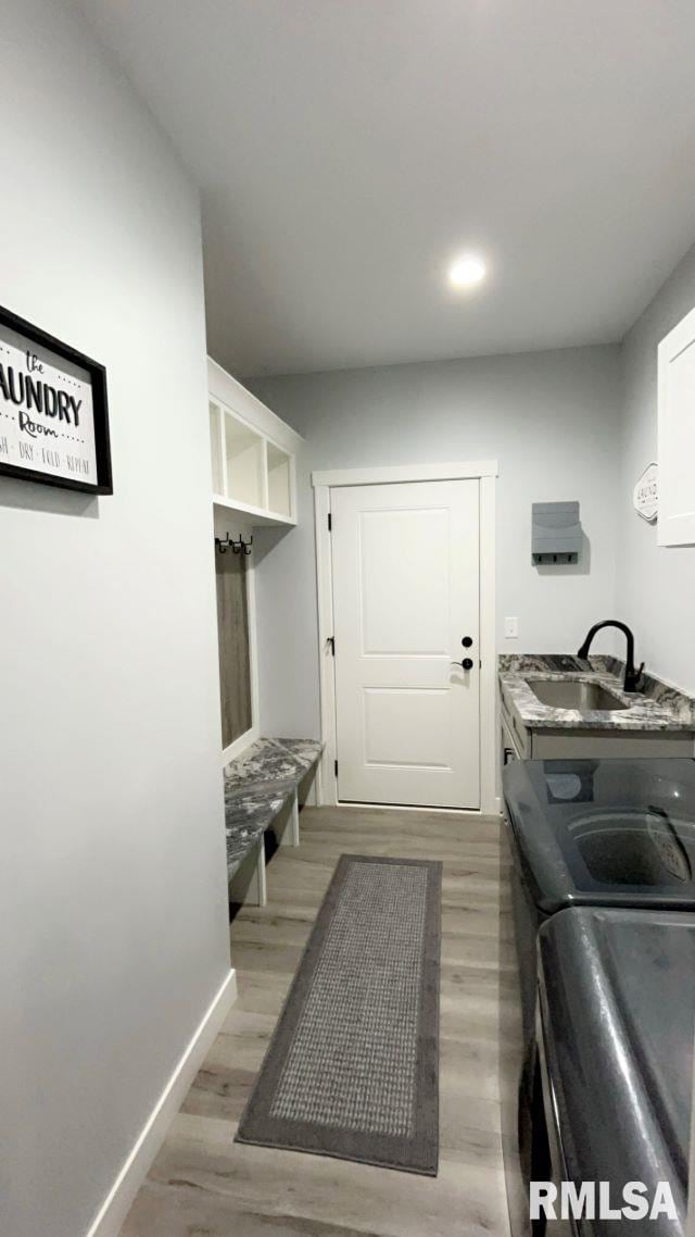 interior space with sink and hardwood / wood-style flooring