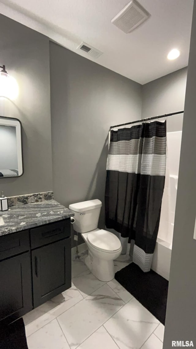 full bathroom featuring vanity, shower / tub combo, and toilet