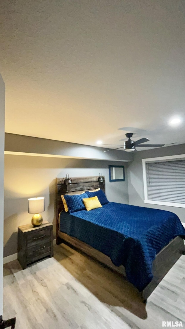 bedroom featuring light hardwood / wood-style flooring and ceiling fan