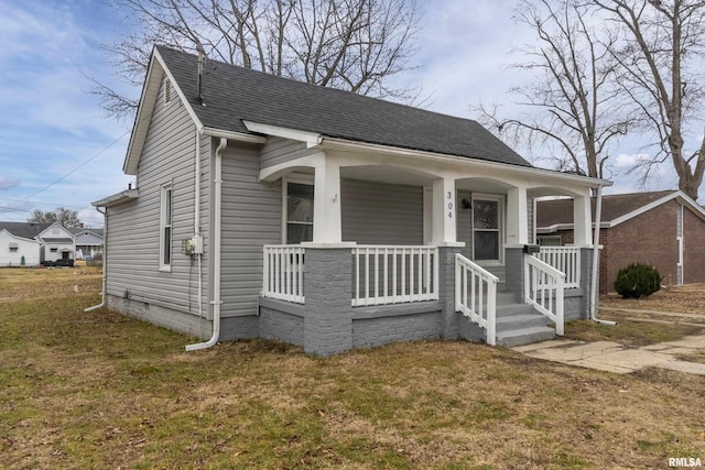 bungalow with a front yard and covered porch