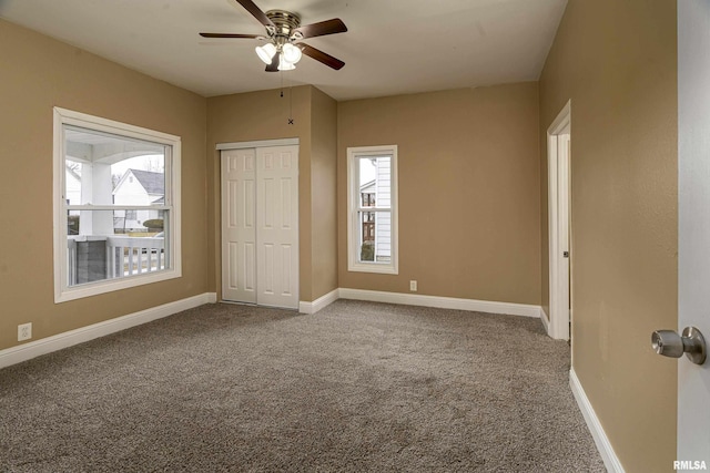 unfurnished bedroom featuring carpet floors, ceiling fan, and a closet