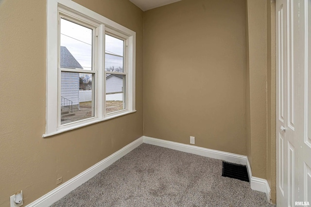 unfurnished room featuring carpet