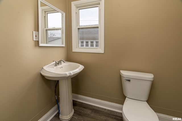 bathroom featuring hardwood / wood-style flooring and toilet