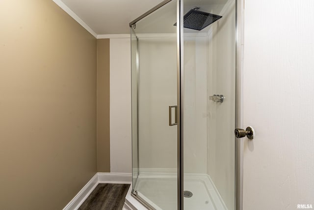 bathroom with a shower with door and hardwood / wood-style floors