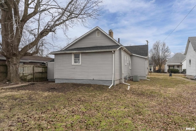 exterior space featuring cooling unit and a yard