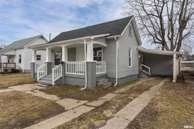 bungalow featuring a porch and a carport