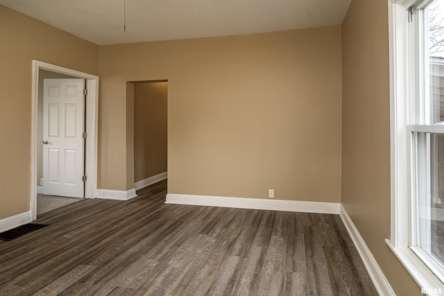 unfurnished room featuring dark wood-type flooring