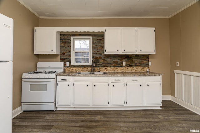 kitchen with sink, white cabinetry, ornamental molding, dark hardwood / wood-style floors, and white appliances