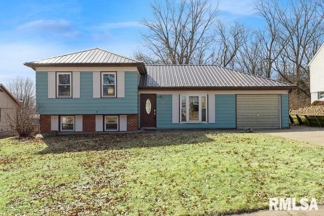 tri-level home with a garage and a front lawn