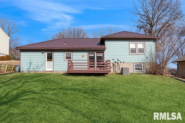 back of house featuring cooling unit, a wooden deck, and a yard