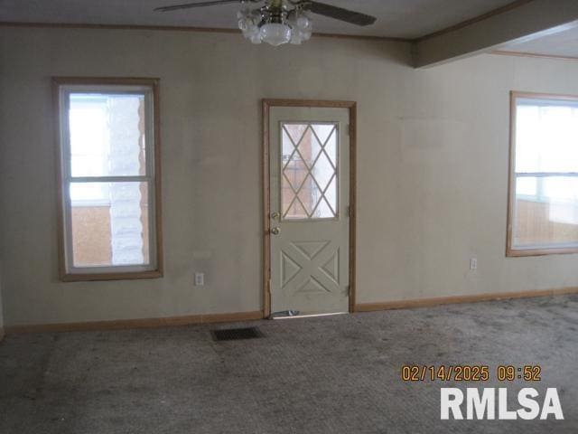 carpeted entrance foyer with ceiling fan