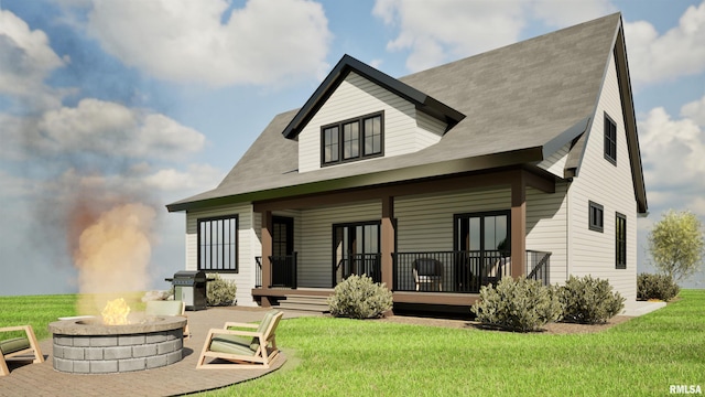 rear view of house with an outdoor fire pit, covered porch, and a lawn