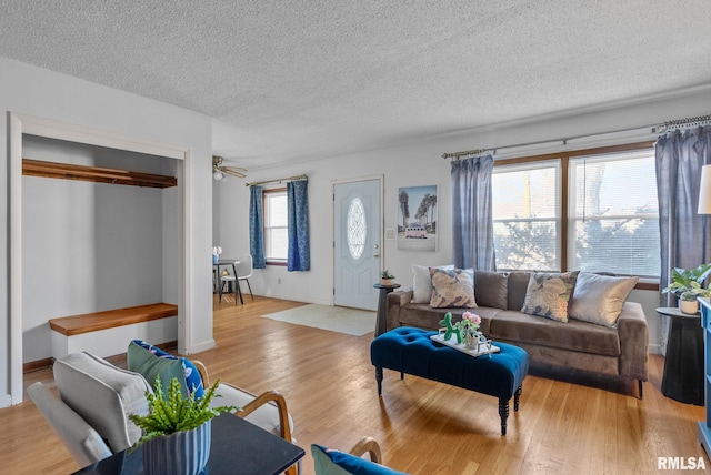 living room featuring a textured ceiling and light wood-type flooring