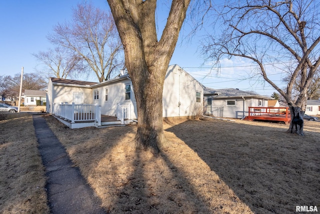 exterior space with a wooden deck and a yard