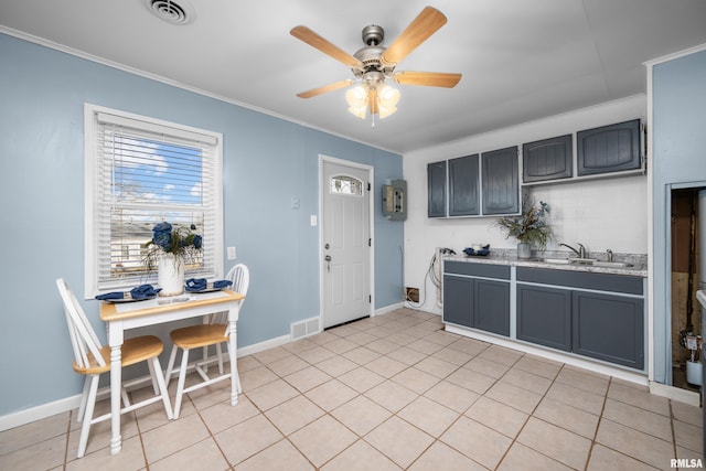 kitchen featuring crown molding, ceiling fan, light tile patterned flooring, and sink