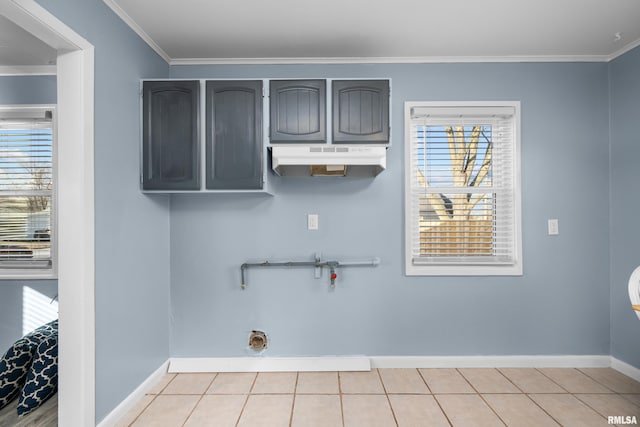 laundry area with cabinets, ornamental molding, electric dryer hookup, and light tile patterned floors