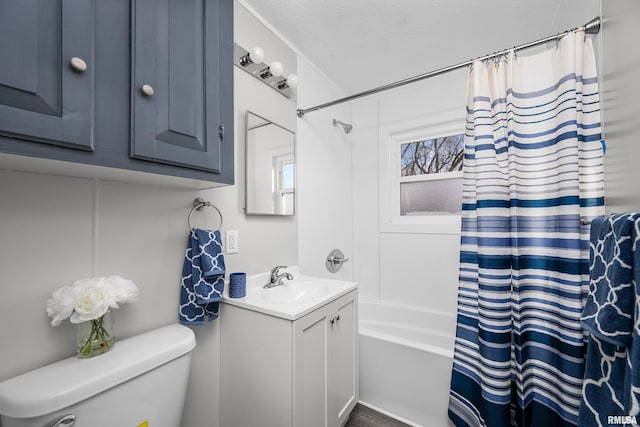 full bathroom featuring vanity, a textured ceiling, shower / bath combination with curtain, and toilet