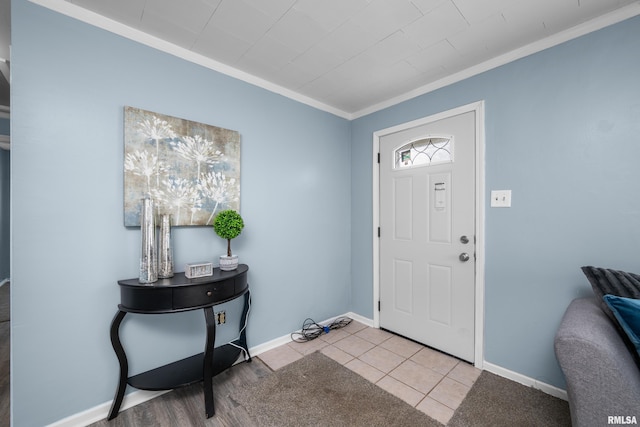 foyer featuring ornamental molding and light tile patterned floors