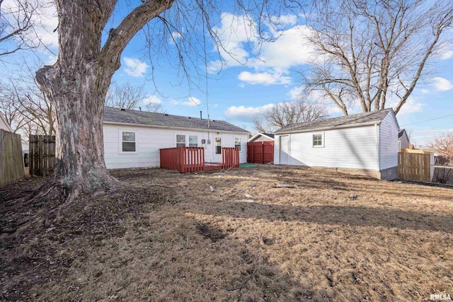 rear view of property with a yard and a deck