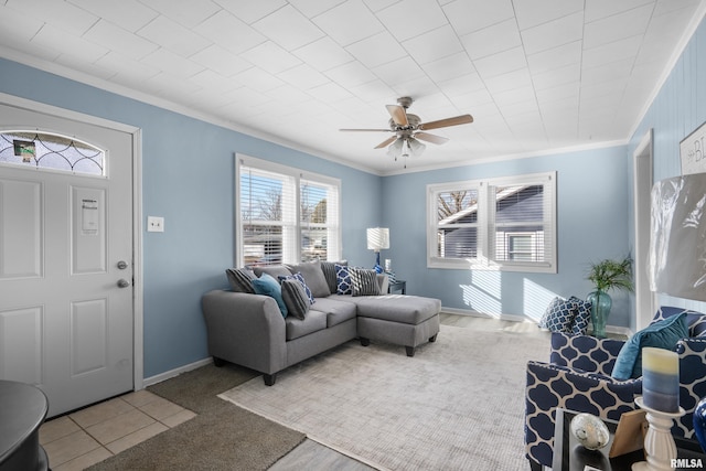 living room with crown molding and ceiling fan