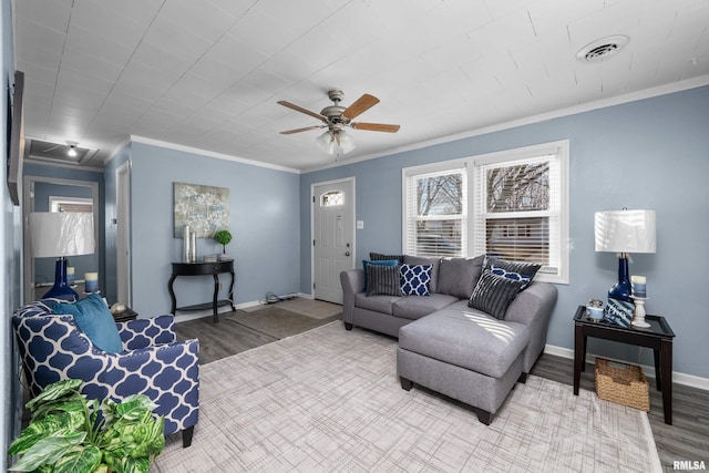 living room with hardwood / wood-style floors, ornamental molding, and ceiling fan