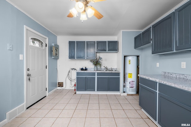 kitchen featuring sink, ornamental molding, water heater, and light tile patterned flooring