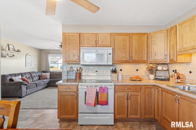 kitchen featuring sink, backsplash, white appliances, ceiling fan, and a textured ceiling