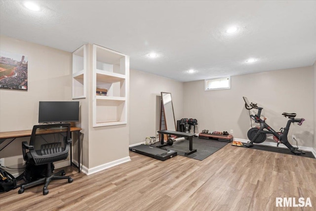 workout room featuring light hardwood / wood-style floors